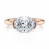14k rose gold east-west half bezel solitaire engagement ring with oval shape diamond