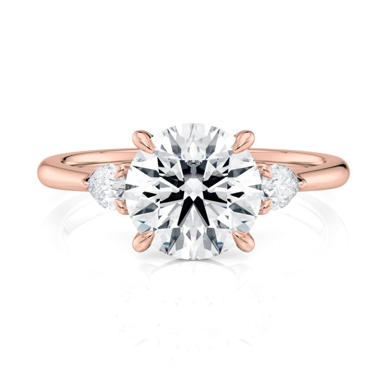 14k rose gold three stone pear lab diamond engagement ring-sits flush with a wedding band with round shape diamond