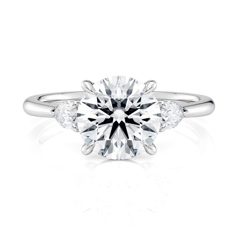 18k white gold three stone pear lab diamond engagement ring-sits flush with a wedding band with round shape diamond