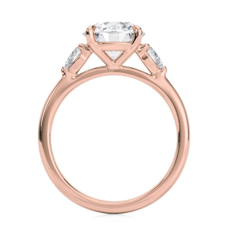 14k rose gold three stone pear lab diamond engagement ring-sits flush with a wedding band with round shape diamond