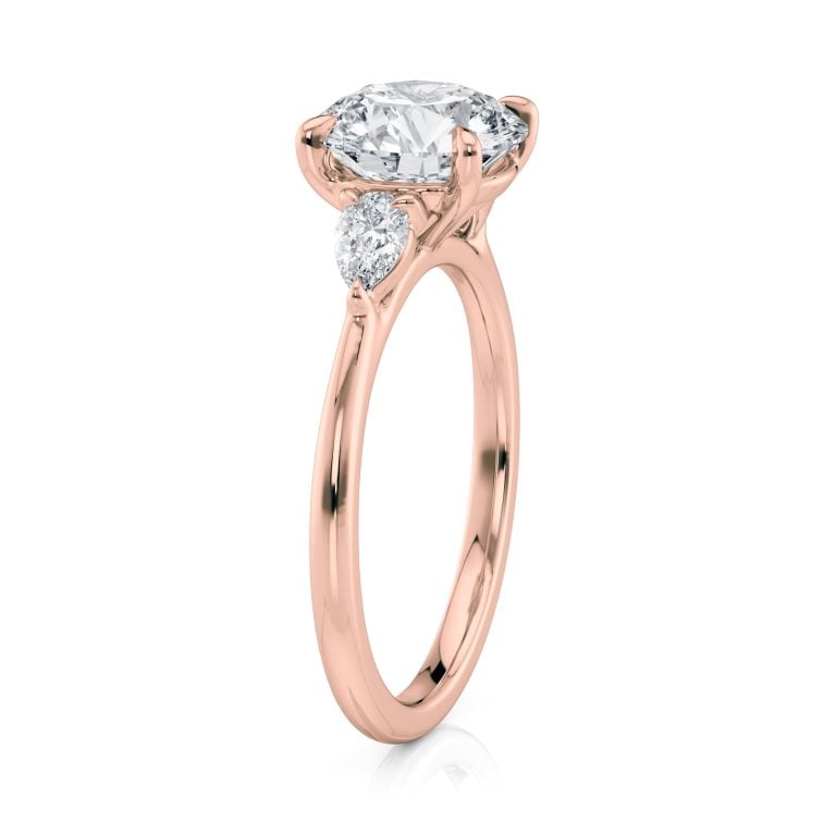 14k rose gold three stone pear lab diamond engagement ring-sits flush with a wedding band with round shape diamond