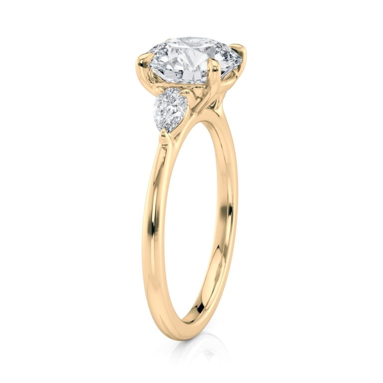 14k yellow gold three stone pear lab diamond engagement ring-sits flush with a wedding band with round shape diamond