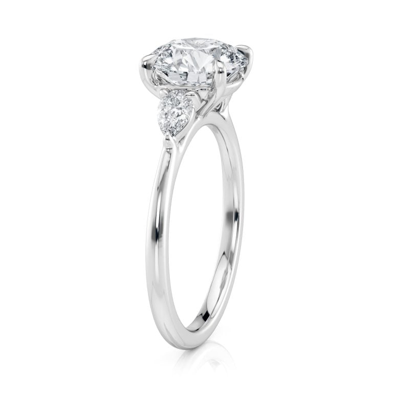 18k white gold three stone pear lab diamond engagement ring-sits flush with a wedding band with round shape diamond
